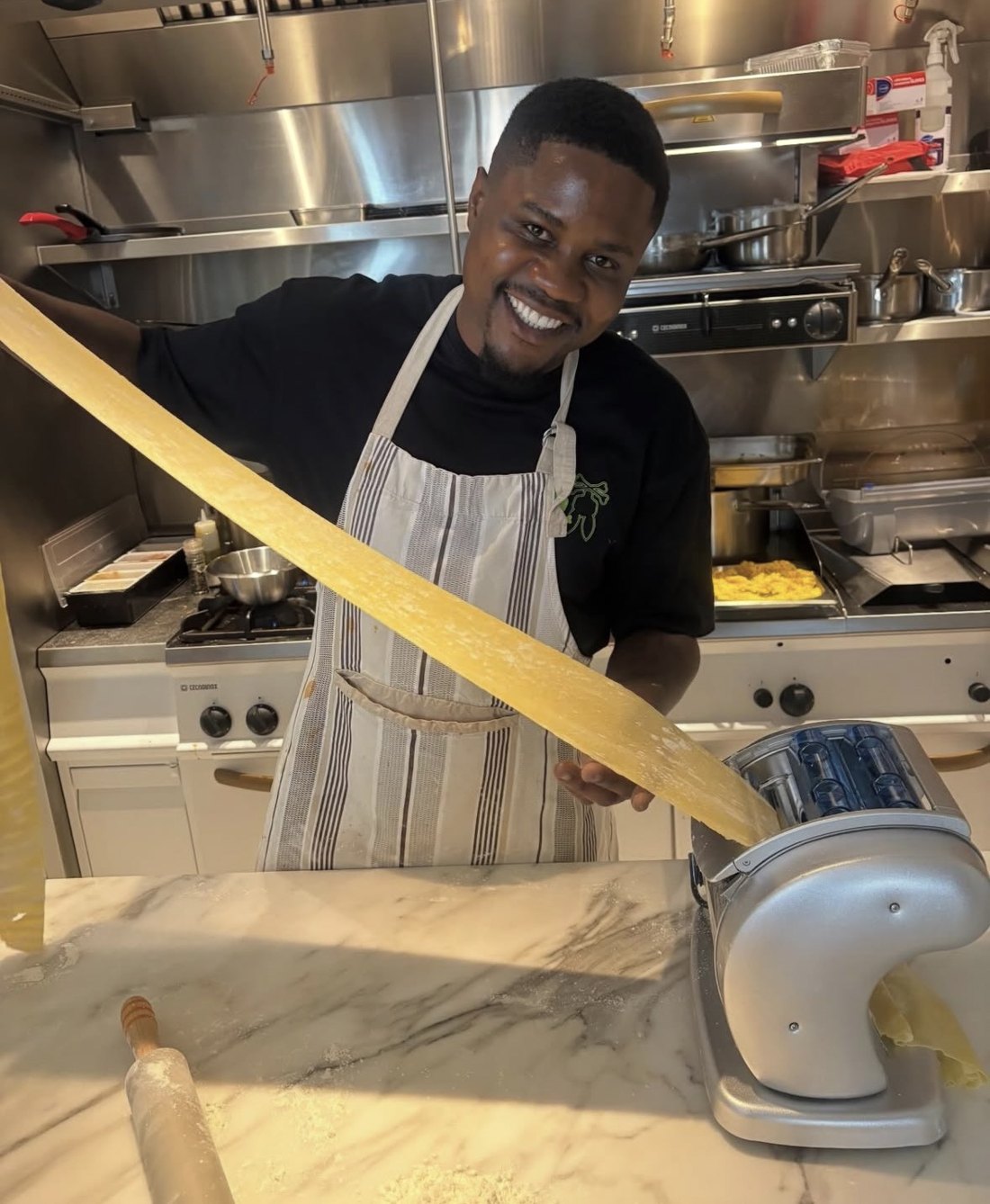 The chef making fresh pasta in the kitchen